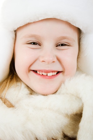 The girl in warm clothes smiling on white background.の写真素材