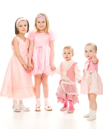 Four friends in a pink dress plays on a white background.の写真素材