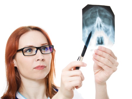 Female doctor examining X-ray image on a white background.