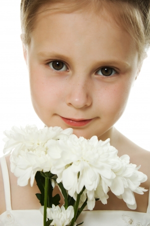 Beautiful girl in white dress with a flower on a white background.の写真素材