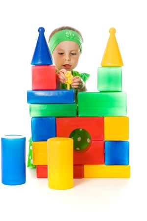 Little girl is playing with toy cubes on a white backgroundの写真素材