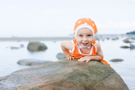 Little baby girl walking on the beachの写真素材