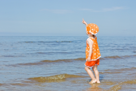 Little baby girl walking on the beachの写真素材