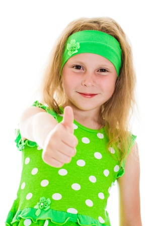 Smiling little girl with thumbs up sign, isolated on whiteの写真素材