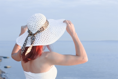 portrait of young beautiful woman in  white hatの写真素材