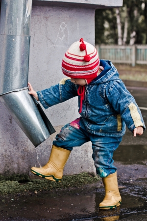 Baby washes up on the street under the drain.の写真素材