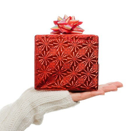 Women's hands hold out a box with a gift on a white background.の写真素材