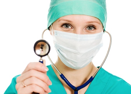 Female surgeon with a stethoscope in hand on a white background.の写真素材