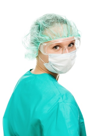 Surgeon woman in protective glasses and mask on whites background.の写真素材