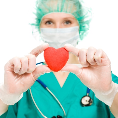 Woman doctor with a heart in his hands on a white backgroundの写真素材