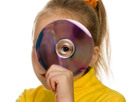 Young girl with a compact disc on a white background.の写真素材