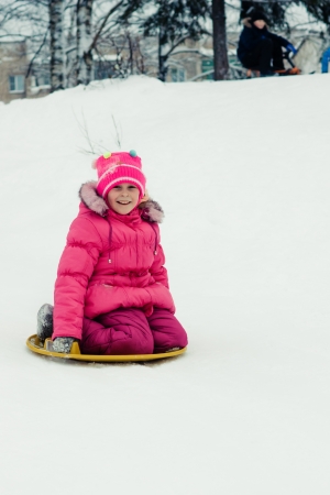 Happy girl in red clothes in winter outdoorsの写真素材