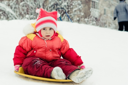 Happy girl in red clothes in winter outdoorsの写真素材