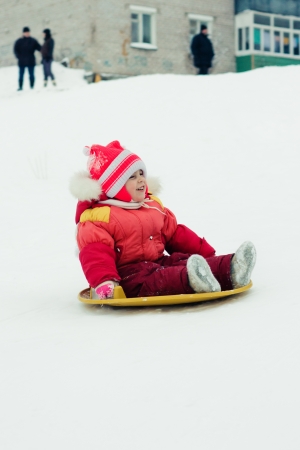 Happy girl in red clothes in winter outdoorsの写真素材