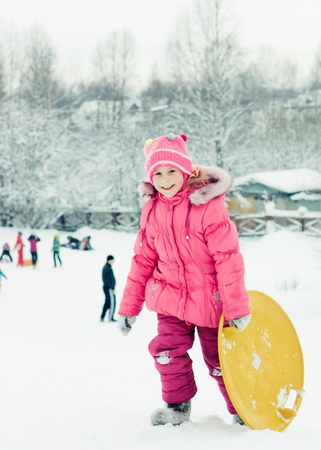 Happy girl in red clothes in winter outdoorsの写真素材