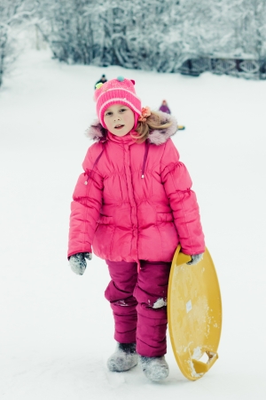 Happy girl in red clothes in winter outdoorsの写真素材