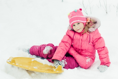 Happy girl in red clothes in winter outdoorsの写真素材