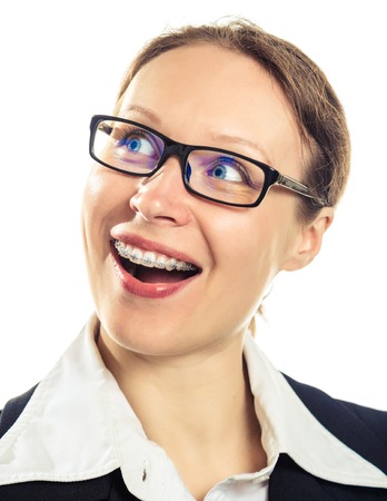 Beautiful smiling girl wearing braces on a white background.の写真素材