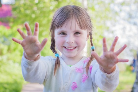 Cute little girl on the meadow in summer day.の写真素材