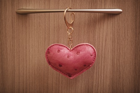Red leather heart on the door handle.の写真素材