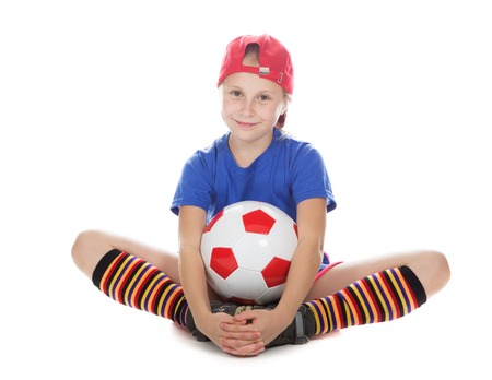 Beautiful girl in a sports cap and a T-shirt with a ball on a white background.の写真素材