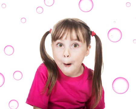 Surprised little girl in red on a white background.の写真素材