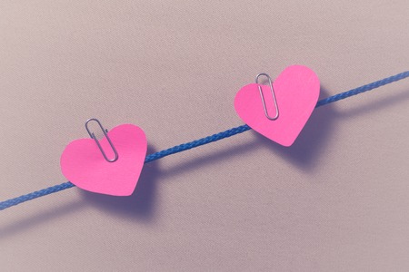 Love for Valentine's day - Red hearts hung together on the rope with isolated background.の写真素材