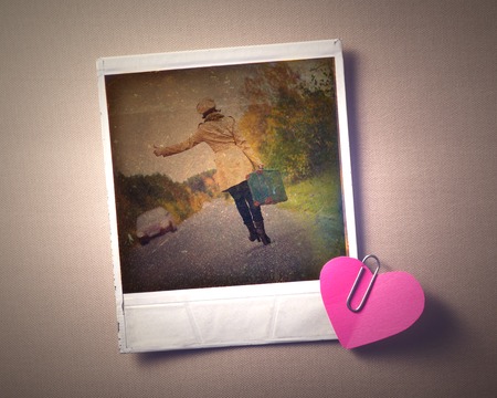 Blank instant photo girl travels and small red paper heart hanging on the clothesline. Photos in retro style.の写真素材