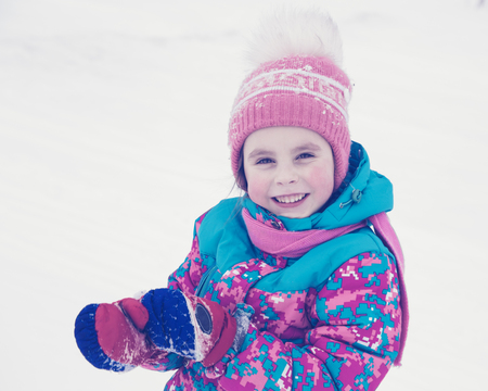 Happy kid winter day playing in the snow. Photos in retro style.