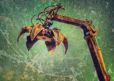 Crane claw on up in recycling center. Photos in a grunge style.の写真素材