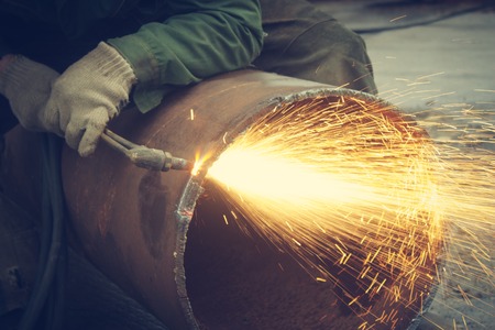 Metal cutting with acetylene torch.Staraya rusty pipe.の写真素材