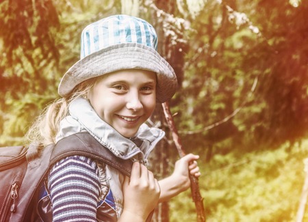 Young girl travels the forests with a backpack.の写真素材
