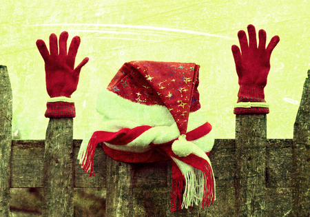 Santa's hat on the wooden fence in the peaceful, inviting, rural environment. Photos in a grunge style.の写真素材
