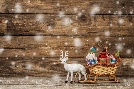 Santa with a snowman and reindeer sledging.の写真素材