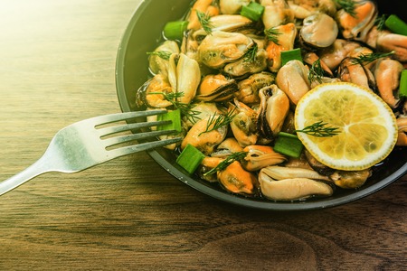 Mussels and vegetables cooked in a rustic style.の写真素材