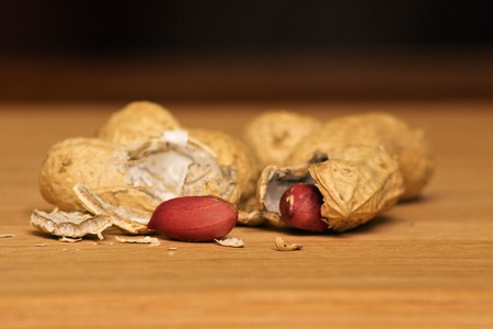 Peanuts in shells on wood background