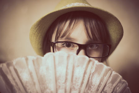 Little girl in hat and glasses.の写真素材