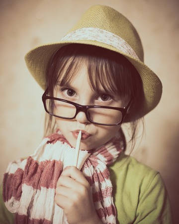 Little girl in hat and glasses.の写真素材