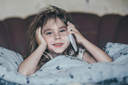 Little girl speaking by cell phoneの写真素材