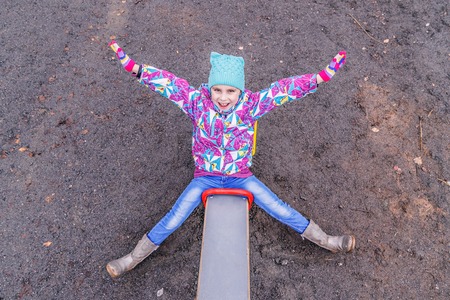 The girl is playing fun on the playground.の写真素材