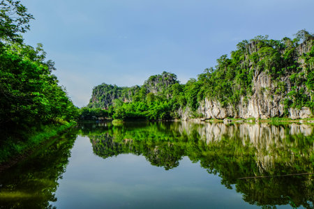green mountain on water and blue sky