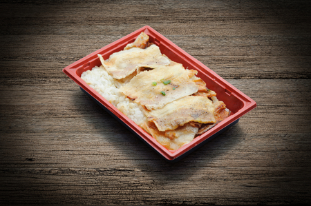 Roasted pork topping on japanese rice in plastic tray. Frozen meal. Microwave foodの写真素材
