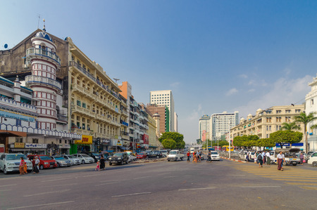 Yangon, Myanmar - Feb 13, 2018: People crossing on the busy street of downtown Yangon