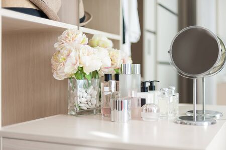 Set of cosmetic cream packaging, lotion bottle and skincare product on dressing tableの写真素材