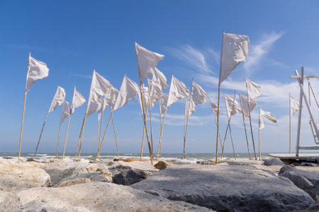 Wind blows white flags on the seashore. Holiday vacation conceptの写真素材