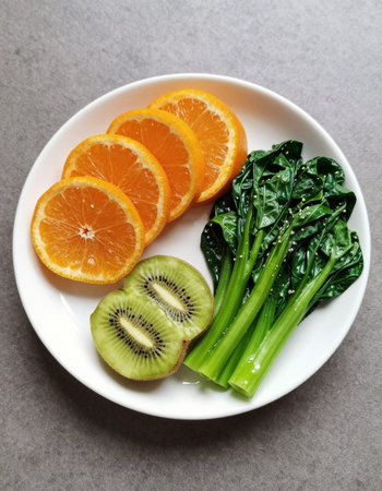 Kiwi, spinach and orange on plate
