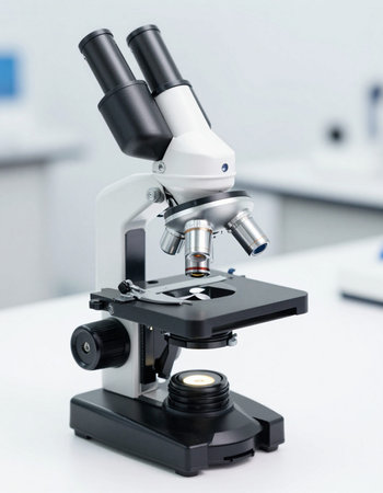 Microscope on a white table in a laboratory. Scientific research and development concept