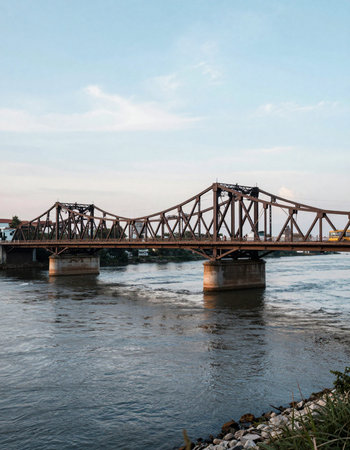 Railway bridge over the river with blue sky background in Thailand.