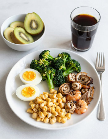 Healthy balanced diet food. Grilled shrimps, broccoli, chickpeas, boiled egg on white background.