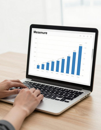 business, finance, statistics and people concept - close up of woman with laptop computer and charts...